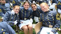 An image taken at VMI's 2022 commencement ceremony. The image is taken of 3 female cadets in the 25th class of coed. 